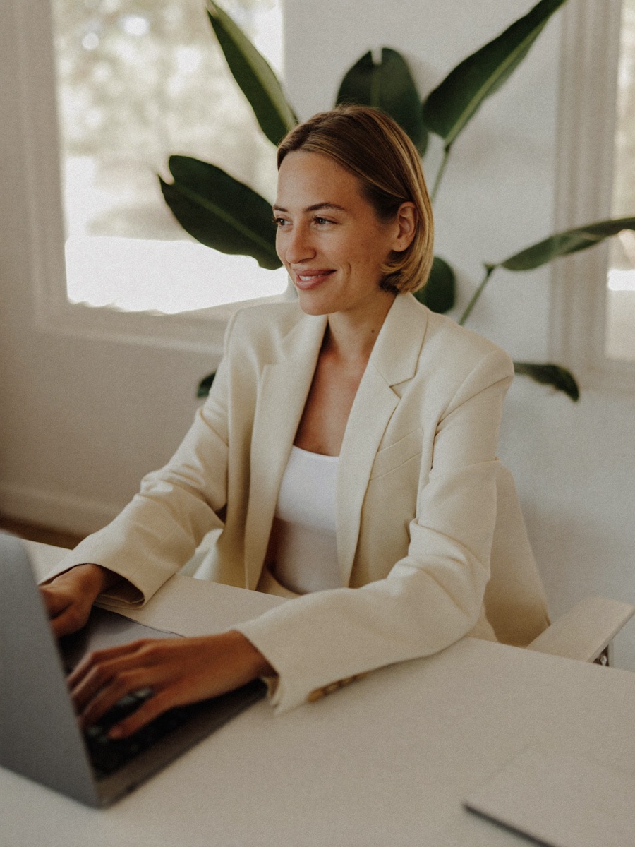 A professional reviewing her CV on a laptop